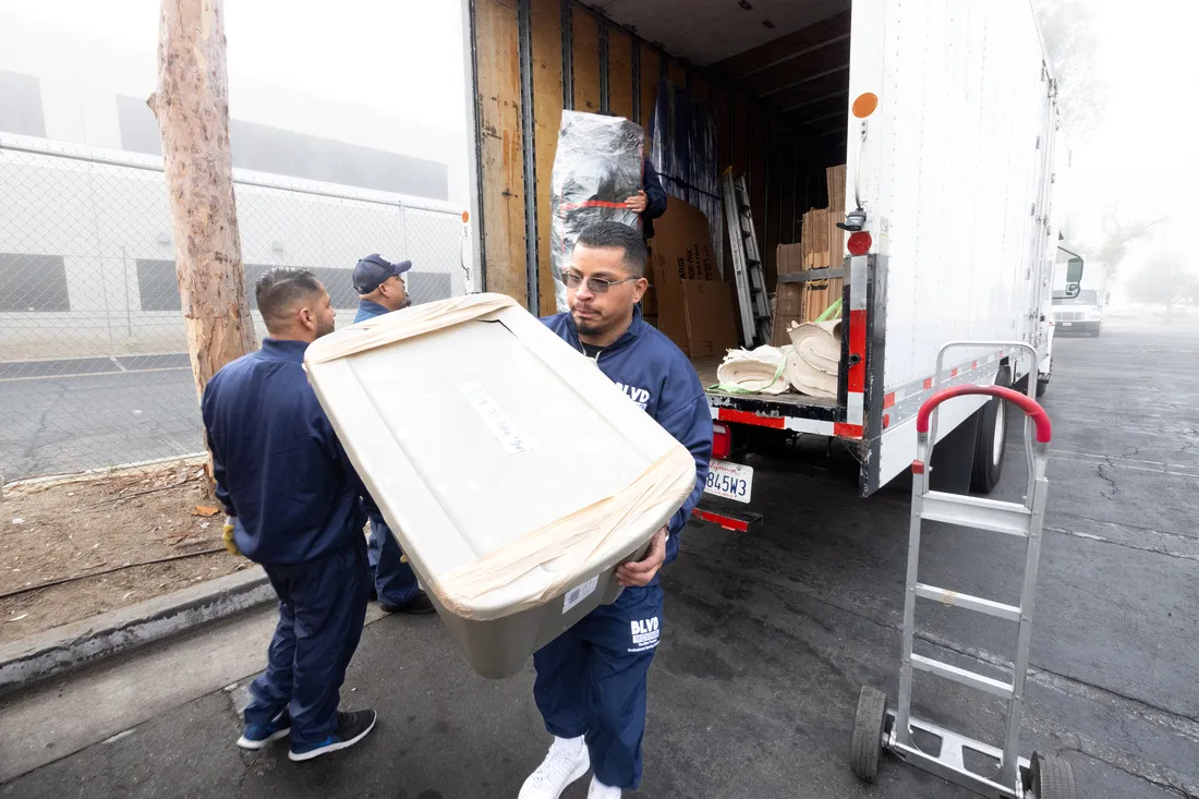 BLVD movers coordinating the safe carry of a storage container