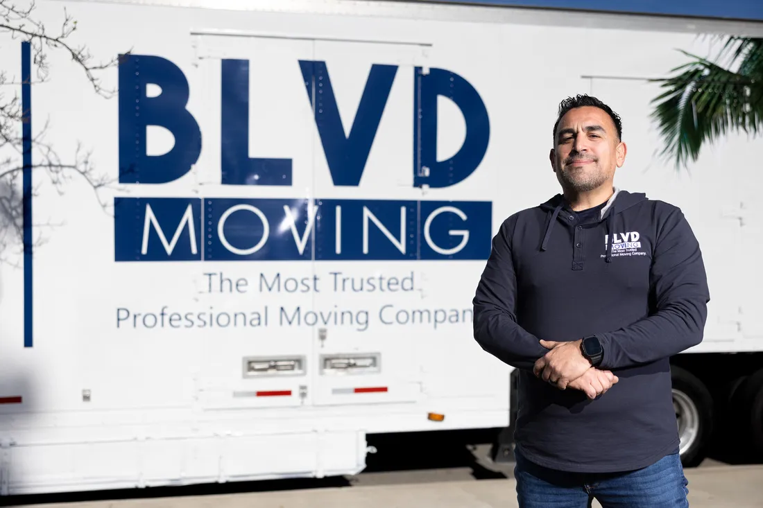 BLVD Moving leadership beside a branded moving truck