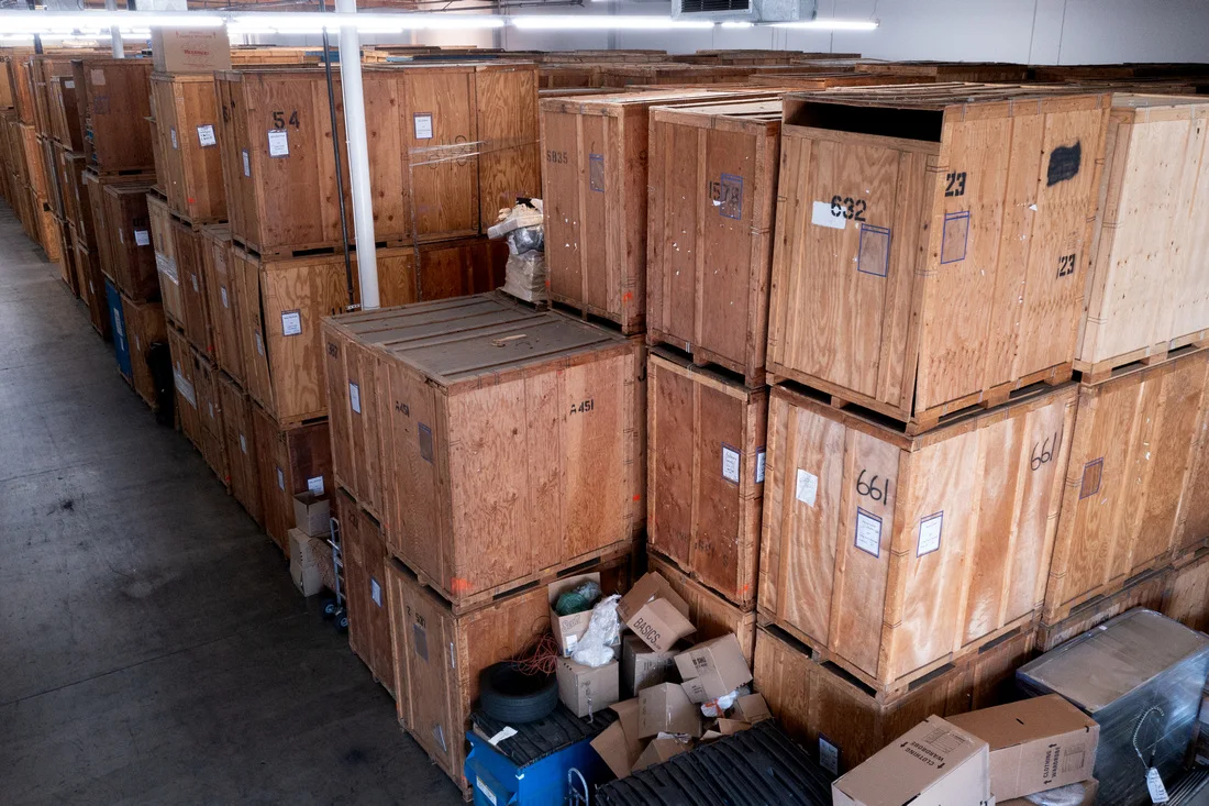 Rows of organized wooden storage vaults inside a warehouse