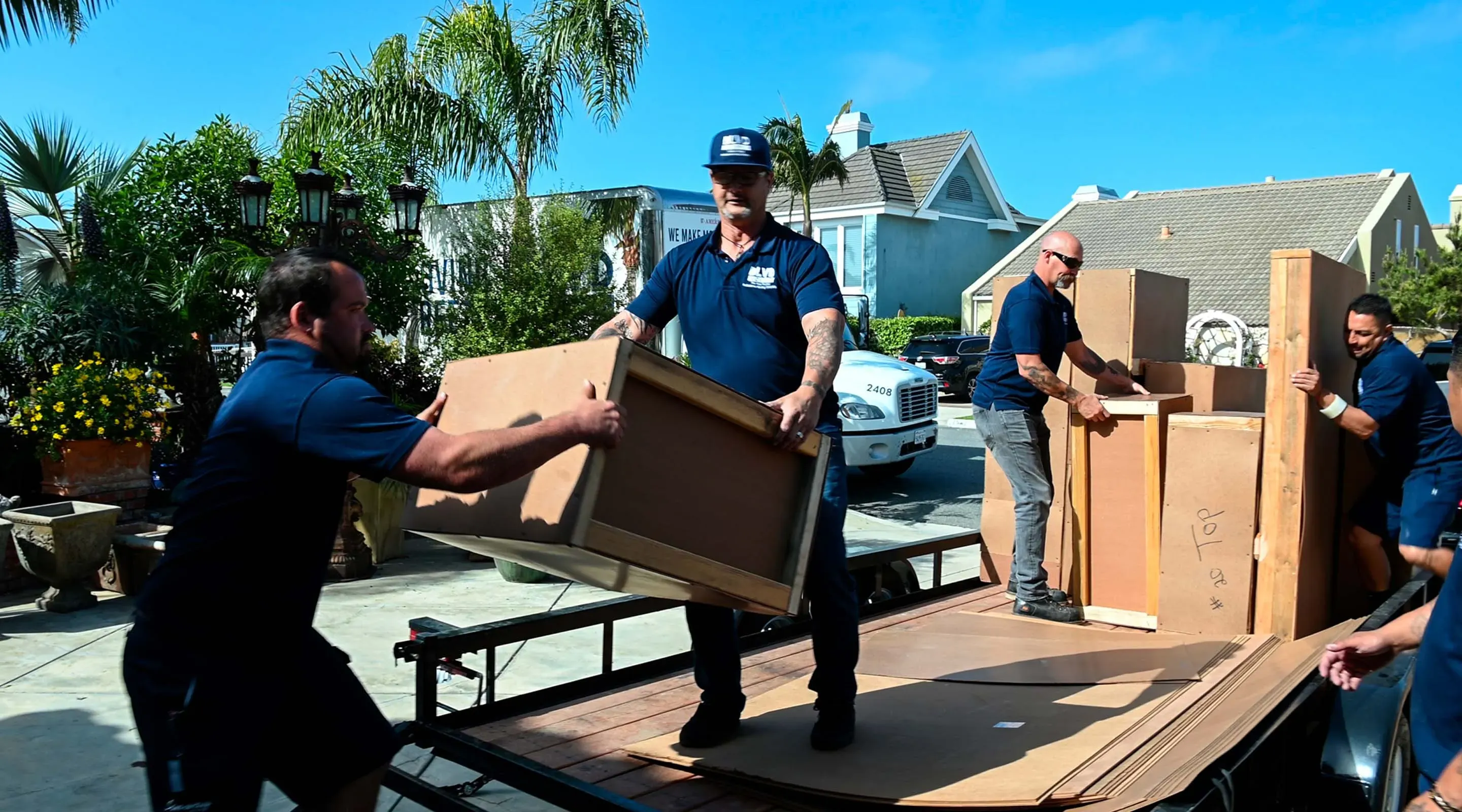 BLVD movers loading protected furniture and moving materials onto a truck