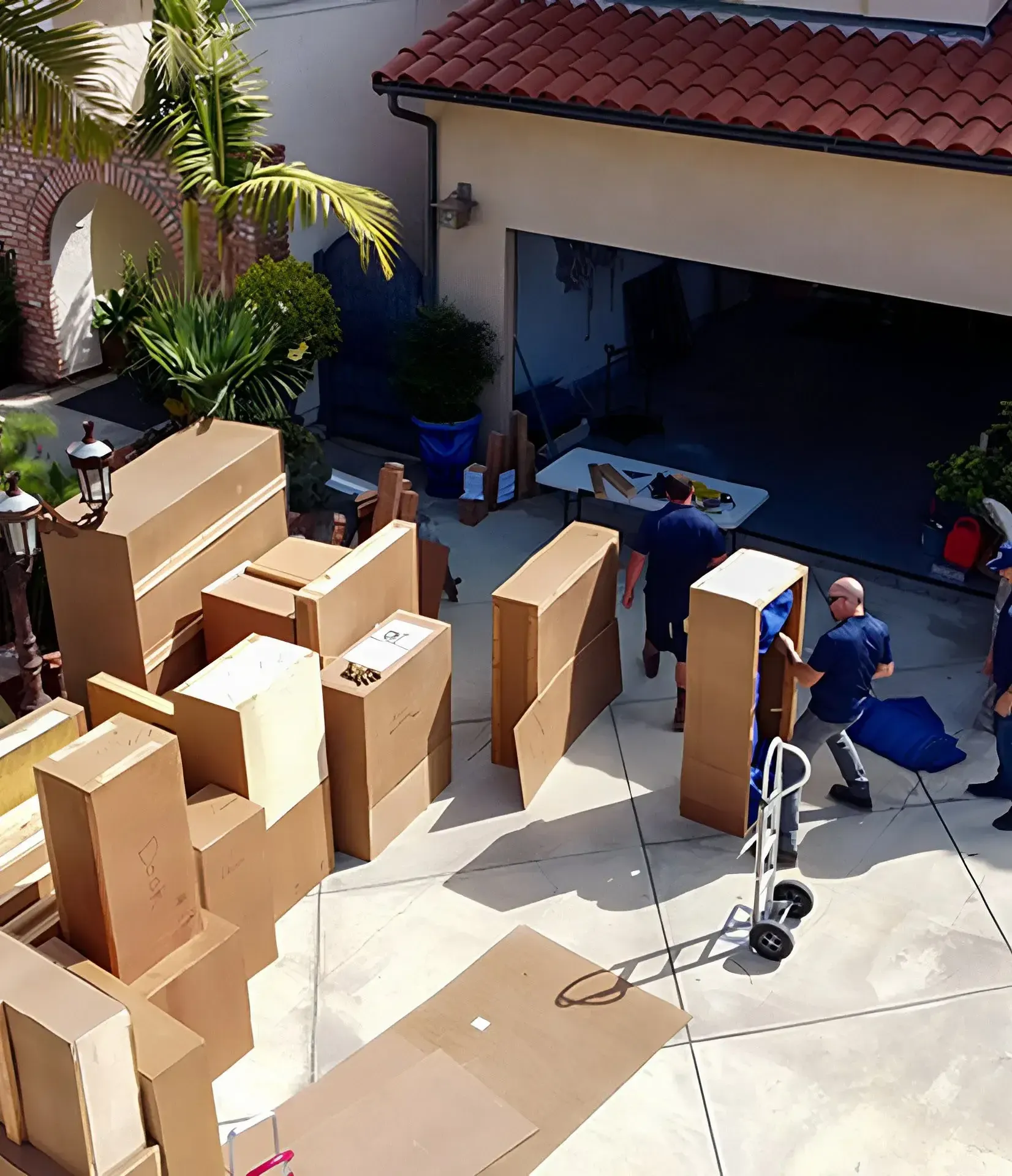 BLVD movers organizing protected moving items outside a home
