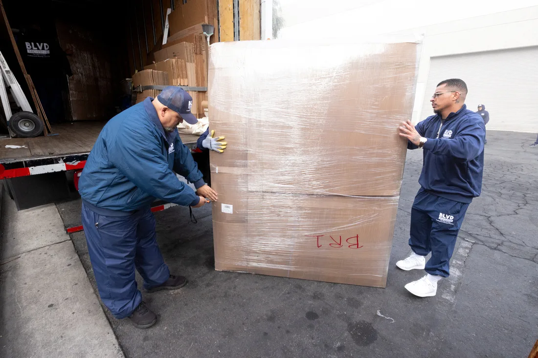 BLVD movers handling wrapped furniture