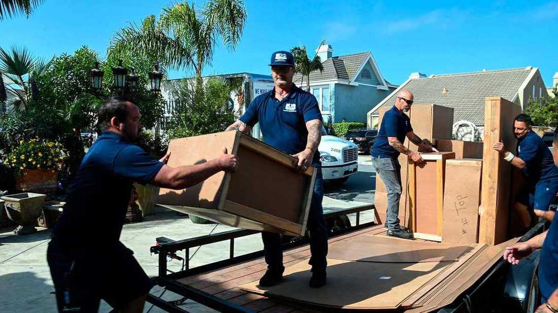 BLVD crew loading custom crates onto a flatbed